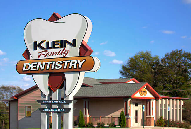 Outside view of Klein Family Dentistry and street sign