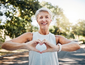 Lady makes shape of heart with her hands