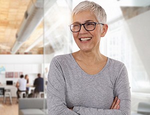 An older businesswoman smiling in an office setting