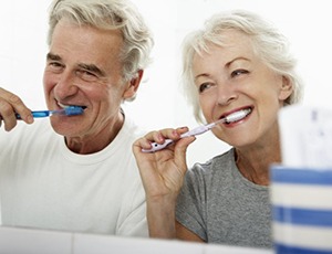 couple brushing their teeth together 