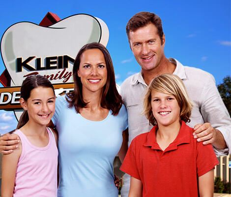 Happy family in front of Klein Family Dentistry