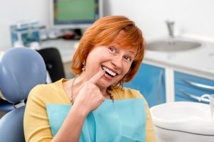 older woman smiling in dentist chair